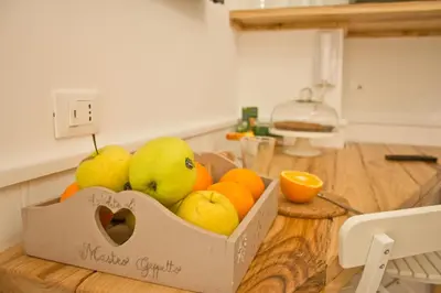 a box of pears and oranges on a table at Glamroom Vatican Apartment in Rome