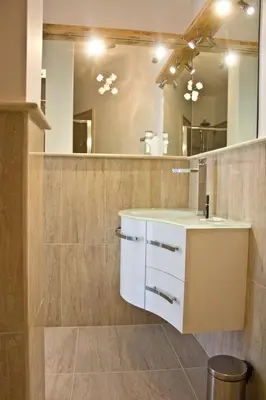 a bathroom with a sink and a mirror at Glamroom Vatican Apartment in Rome