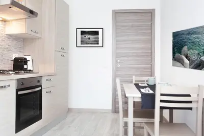 a kitchen with a table and a dining room at New Tiburtina in Rome