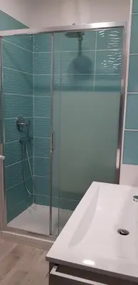 a bathroom with a shower with a glass door at New Tiburtina in Rome