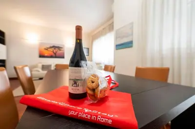 a bottle of wine and some donuts on a table at St Peter new and lightsome apartment with balcony in Rome