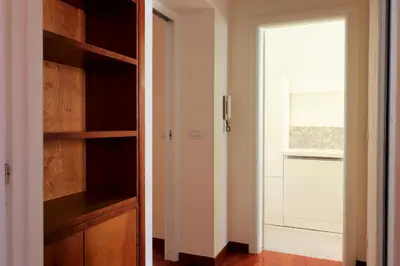a room with a closet with a door and a window at St Peter new and lightsome apartment with balcony in Rome