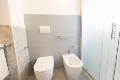 a bathroom with a white toilet and a bidet at St Peter new and lightsome apartment with balcony in Rome