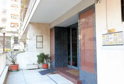an entrance to a building with potted plants at St Peter new and lightsome apartment with balcony in Rome