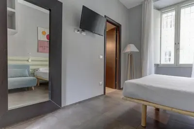 a bedroom with a bed and a large mirror at CAPO D'AFRICA 30 - COLOSSEO in Rome