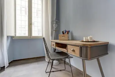 a desk with a chair next to a window at CAPO D'AFRICA 30 - COLOSSEO in Rome