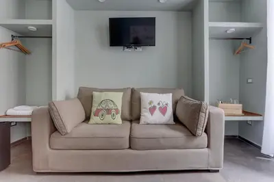 a living room with a couch with two pillows on it at CAPO D'AFRICA 30 - COLOSSEO in Rome