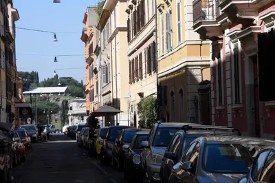 a street with cars parked on the side of the road at CAPO D'AFRICA 30 - COLOSSEO in Rome