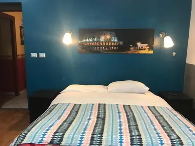 a bedroom with a bed with a blue wall at La Casa di Elena in Rome