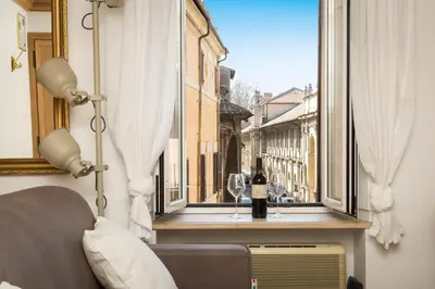 a bottle of wine sitting on a window sill at Giuditta Suite 121 Trastevere Roma in Rome