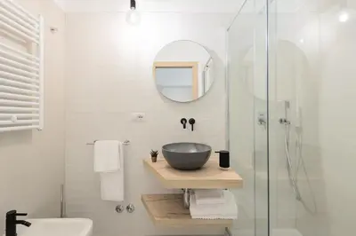a bathroom with a bowl sink and a shower at Numa Roma Guesthouse in Rome