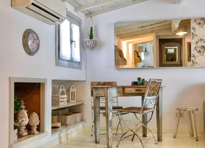 an old wooden table in a room with a mirror at Boutique Apartment Roma in Trastevere in Rome