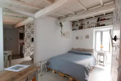 a bedroom with a bed and a desk and a window at Boutique Apartment Roma in Trastevere in Rome
