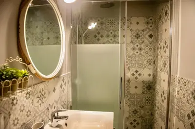 a bathroom with a shower and a sink and a mirror at Boutique Apartment Roma in Trastevere in Rome