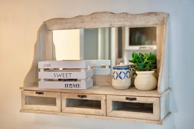 a mirror on top of a dresser with boxes at Boutique Apartment Roma in Trastevere in Rome