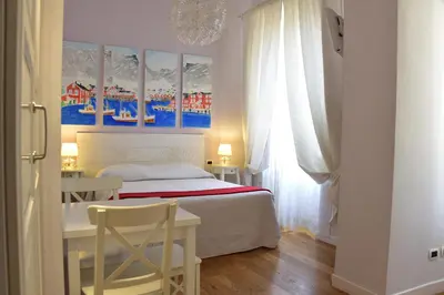 a bedroom with a bed and a desk with a chair at Casa Martini in Rome
