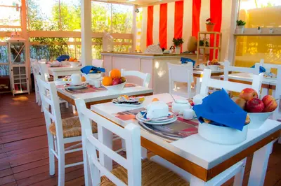 a dining room with a table and chairs with fruit on it at Casa Martini in Rome