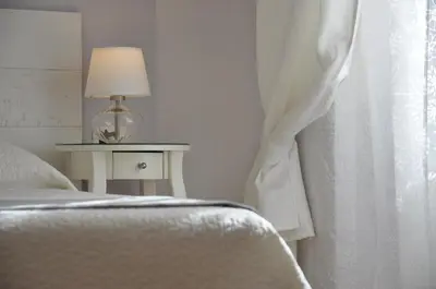 a bedroom with a bed and a window with a lamp at Casa Martini in Rome