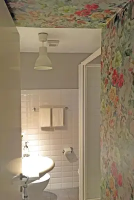 a bathroom with a sink and a flower patterned ceiling at M SuiteApartment Roma in Rome