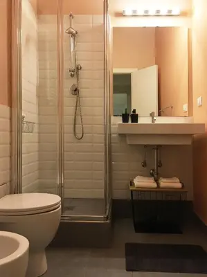 a bathroom with a shower and a toilet and a sink at M SuiteApartment Roma in Rome