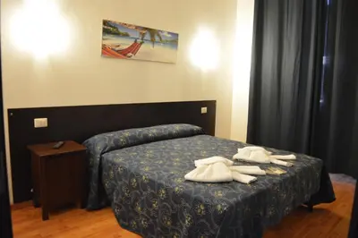 a bedroom with a bed with towels on it at Locanda Otello in Rome