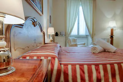 a bedroom with a bed and a table with a lamp at Armonia All'Opera in Rome
