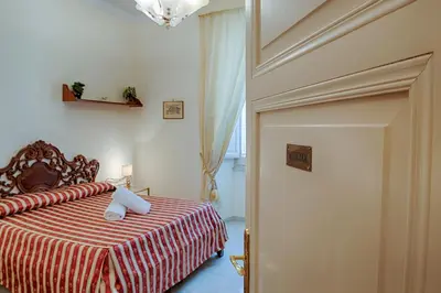 a bedroom with a bed with a red and white blanket at Armonia All'Opera in Rome