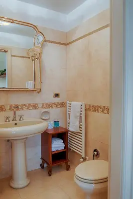 a bathroom with a sink and a toilet at Armonia All'Opera in Rome