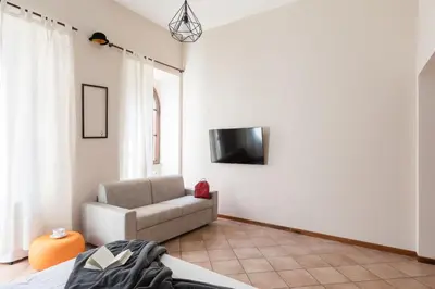 a living room with a couch and a tv at A World Aparts - 40 Sforza in Rome