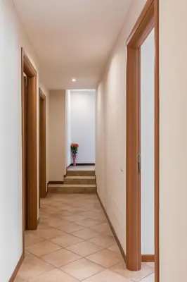 an empty hallway with a plant in a vase at A World Aparts - 40 Sforza in Rome