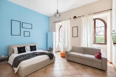 a bedroom with a bed and a couch at A World Aparts - 40 Sforza in Rome