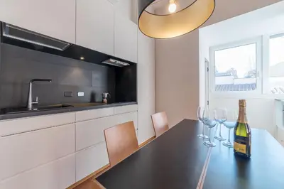a kitchen with a table with wine glasses on it at Monti Stunning Apartment with Terrace in Rome