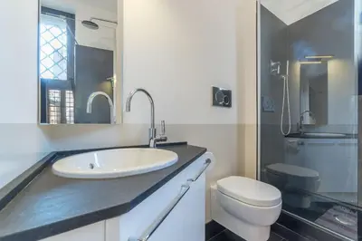 a white bathroom with a sink and a toilet at Monti Stunning Apartment with Terrace in Rome