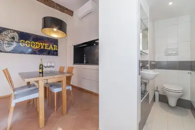 a dining room with a table and a toilet at Monti Stunning Apartment with Terrace in Rome