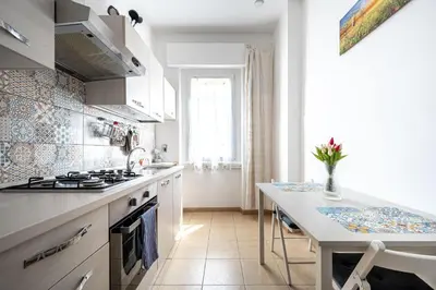 a kitchen with a sink and a stove top oven at Caracciolo Apartment - Metro San Giovanni in Rome