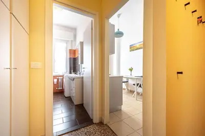 a hallway leading to a kitchen with yellow walls at Caracciolo Apartment - Metro San Giovanni in Rome