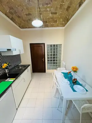 a kitchen with a white table and chairs in a room at B&B Rome Terminal House in Rome