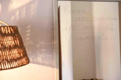 a sign on a wall with a bag next to it at Luma Home in Rome