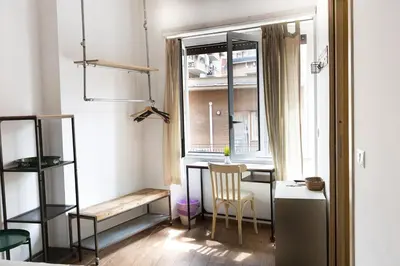 a room with a table and a chair and a window at Luma Home in Rome