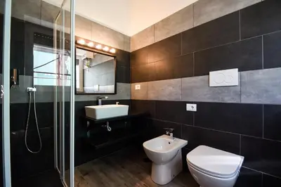 a bathroom with a toilet and a sink and a shower at Luma Home in Rome