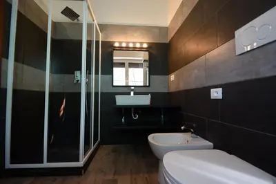 a bathroom with a toilet and a sink and a mirror at Luma Home in Rome