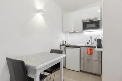 a small kitchen with a table and a counter top at Dolce Vita New Studio in Rome
