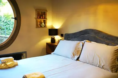 a bedroom with a white bed with a large window at Domus Luxury Gianicolo in Rome