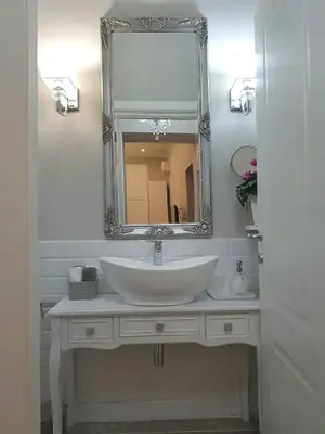 a bathroom with a white sink and a mirror at Casa De Rose in Rome