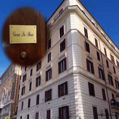a building with a sign on the side of it at Casa De Rose in Rome