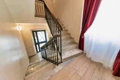 a staircase in a home with a red curtain at Hotel Balilla in Rome
