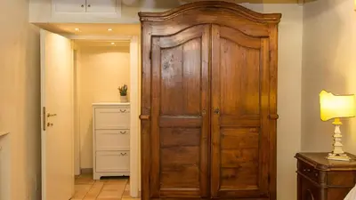 a large wooden door in a hallway with a lamp at Rental in Rome Falegnami in Rome