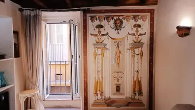 a door with a painting on it next to a window at Rental in Rome Falegnami in Rome