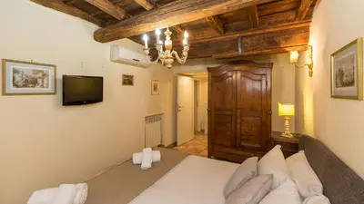a bedroom with a bed and a television in a room at Rental in Rome Falegnami in Rome