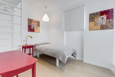a bedroom with a bed and a red table at Lovely 3 rooms apartment close Trastevere Station in Rome